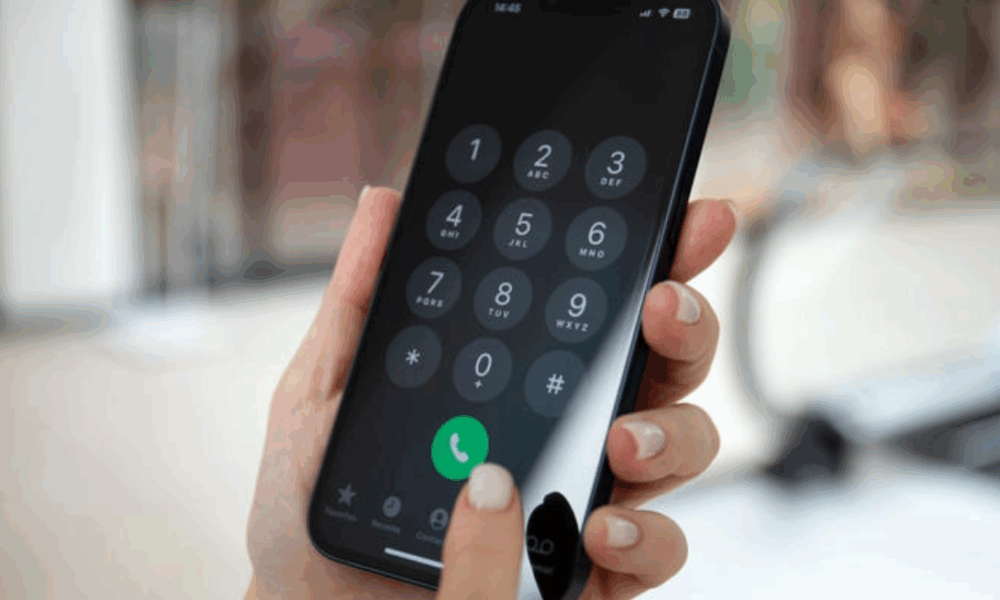 a hand holding a phone with a number on the screen